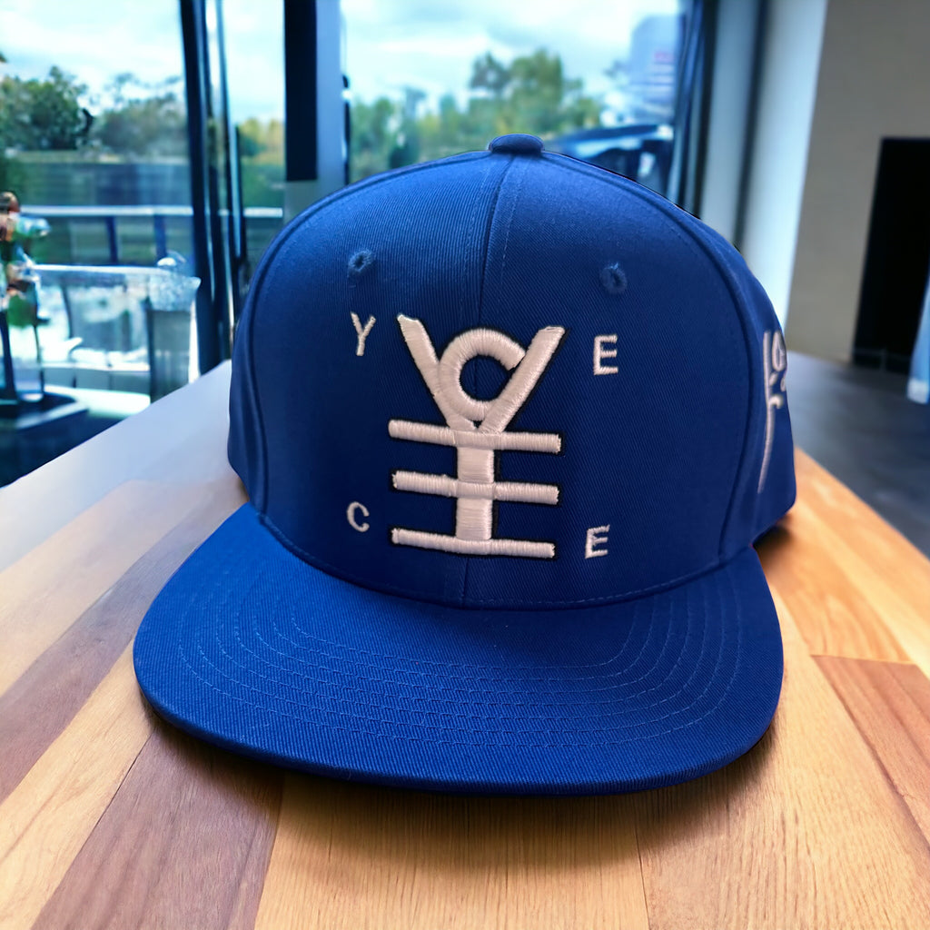 Blue cap with white logo on a wooden surface