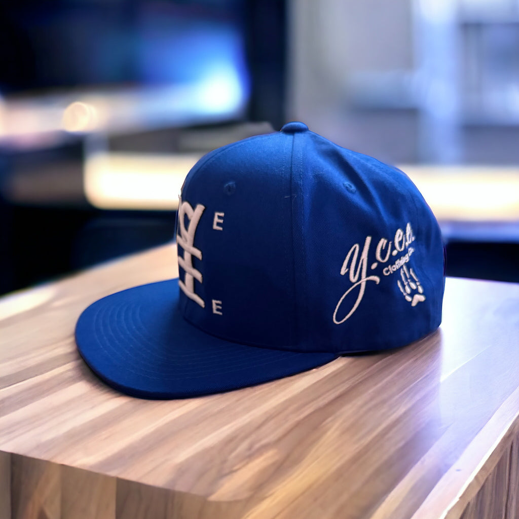 Blue cap with white text on a wooden surface