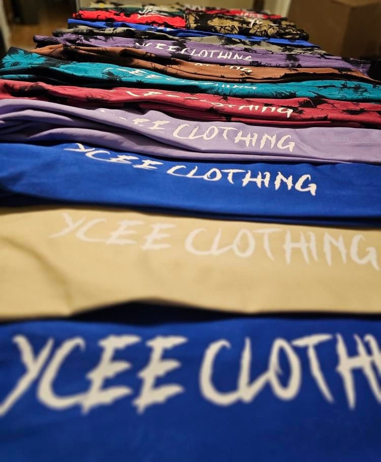 Stack of folded clothing with 'YCEE Clothing' branding.